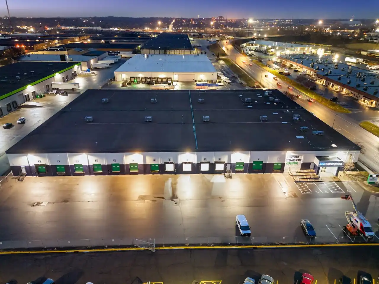WareSpace facility at dusk showing the scale of the building and lit loading docks